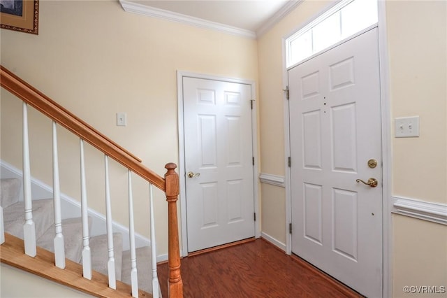 foyer featuring crown molding, stairs, and wood finished floors