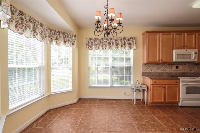 kitchen with backsplash, tile patterned flooring, baseboards, a notable chandelier, and white appliances