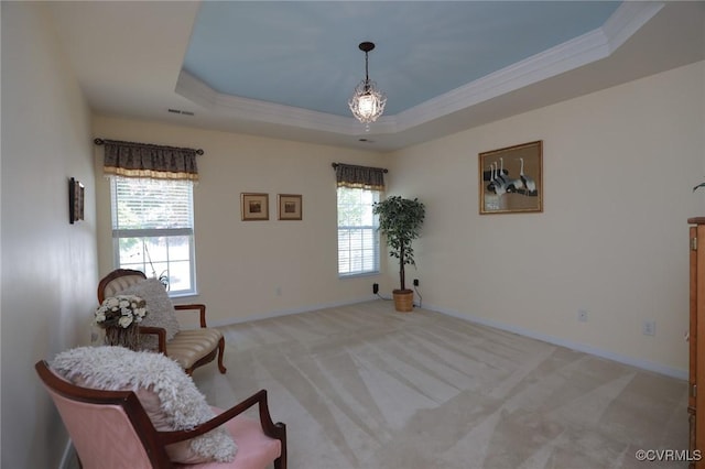 sitting room with crown molding, baseboards, a tray ceiling, and light colored carpet
