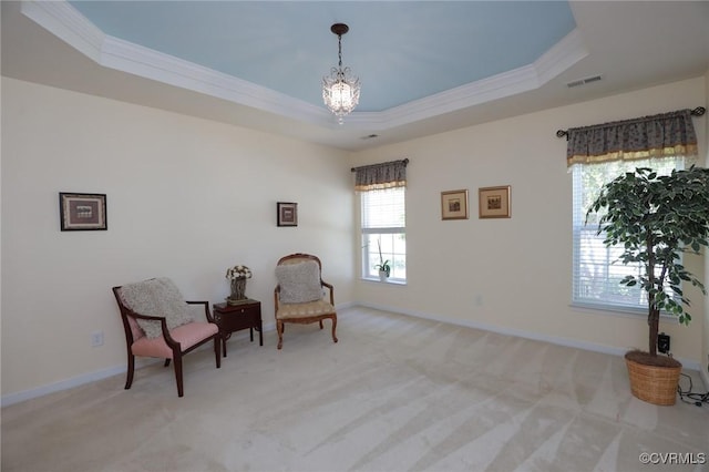living area with visible vents, crown molding, a notable chandelier, and a tray ceiling