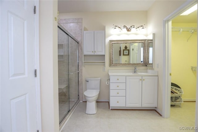 full bath with vanity, tile patterned floors, a stall shower, and toilet