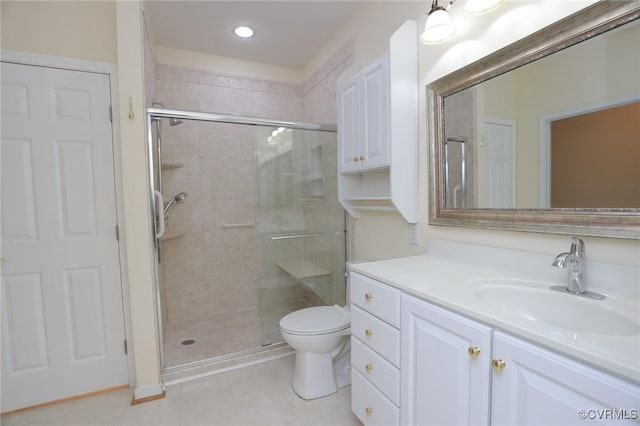 full bathroom featuring vanity, tile patterned floors, a stall shower, and toilet