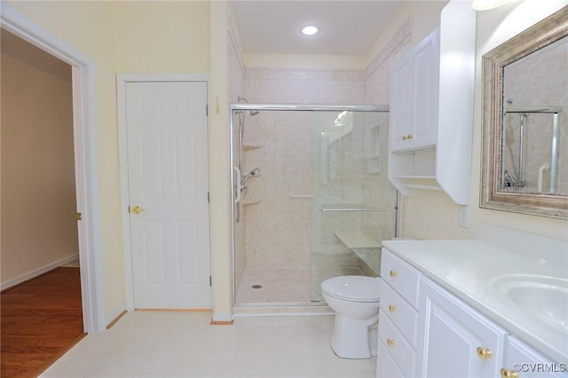 bathroom with vanity, recessed lighting, a stall shower, and toilet