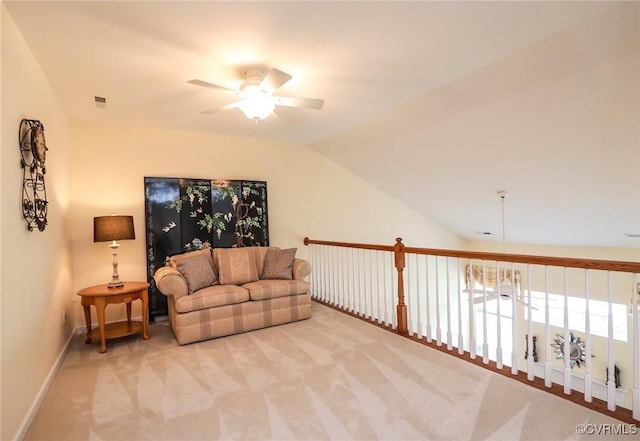 living room featuring a ceiling fan, baseboards, light colored carpet, and vaulted ceiling