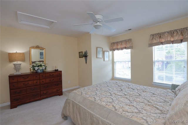carpeted bedroom with a ceiling fan and attic access