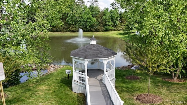 view of dock featuring a lawn, a water view, and a gazebo