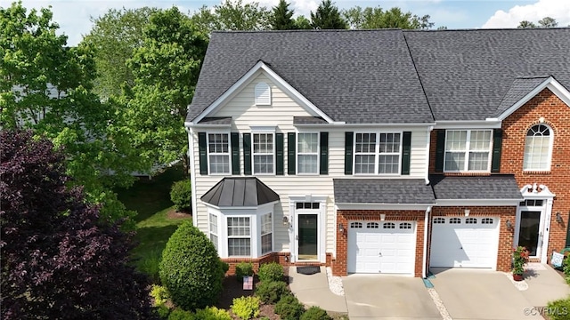 view of front facade featuring brick siding, an attached garage, roof with shingles, and driveway
