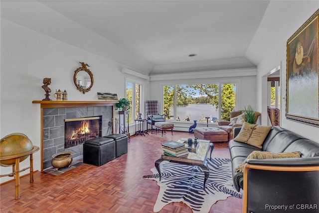 555 Rio Vis, Irvington, VA 22576 - living area featuring a tiled fireplace, a water view, and lofted ceiling