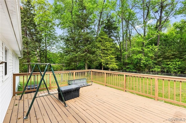 wooden terrace with a lawn and a fenced backyard