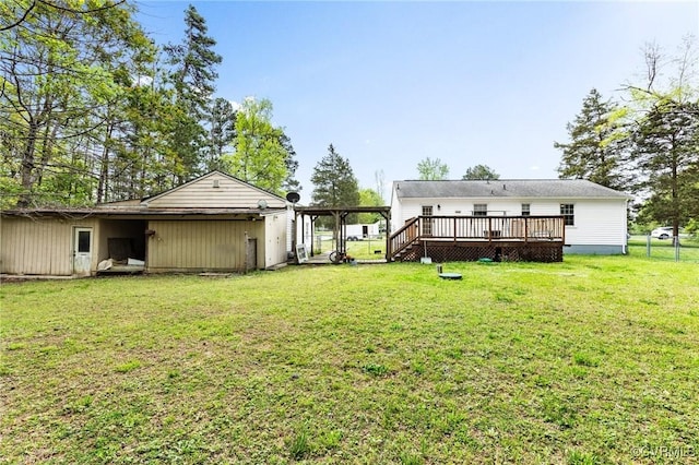 rear view of property with a deck and a yard