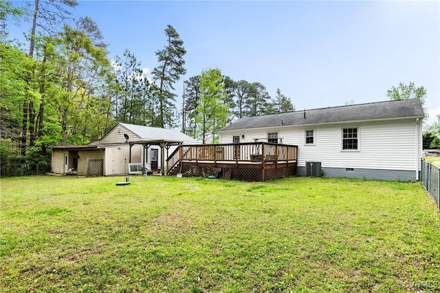 back of property with a deck, cooling unit, a lawn, and crawl space