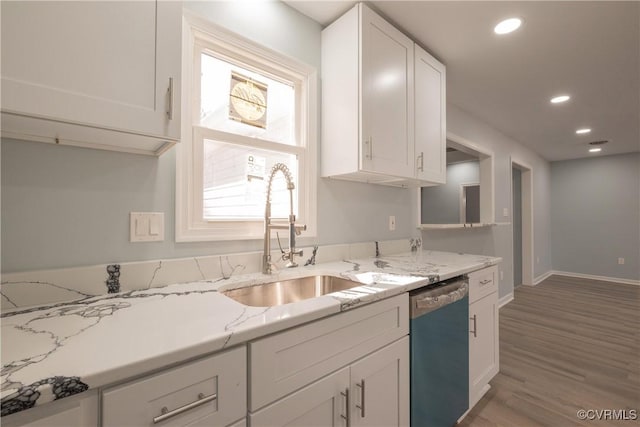 kitchen featuring recessed lighting, light stone countertops, white cabinetry, dishwasher, and wood finished floors