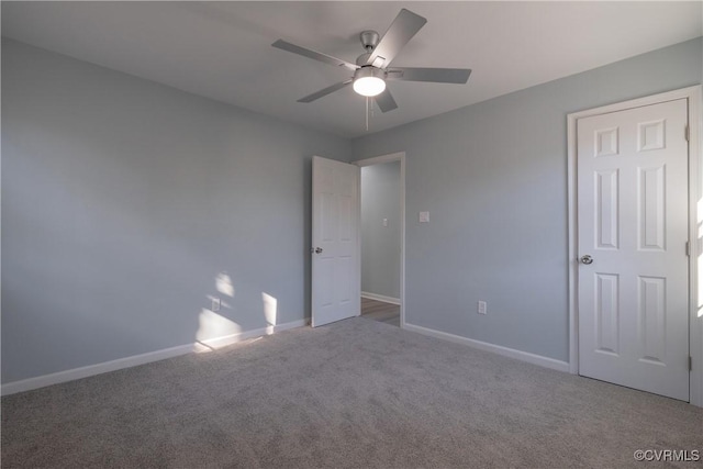 unfurnished bedroom featuring ceiling fan, carpet, and baseboards