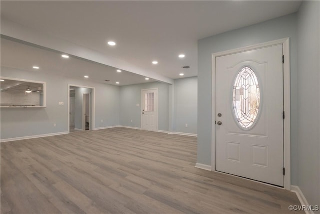 entryway with wood finished floors, recessed lighting, and baseboards