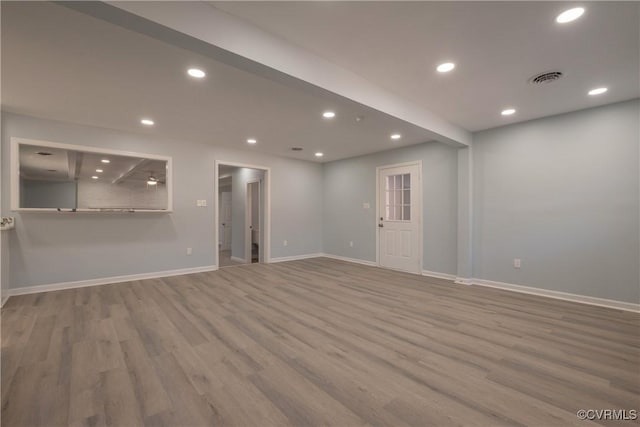 spare room featuring recessed lighting, visible vents, wood finished floors, and baseboards
