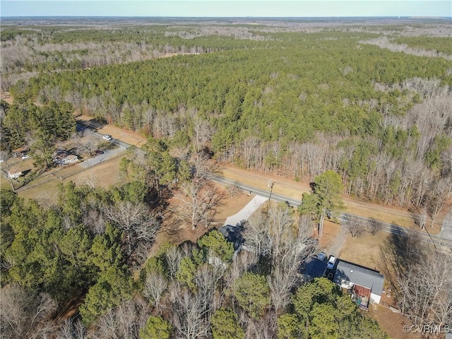 birds eye view of property featuring a wooded view