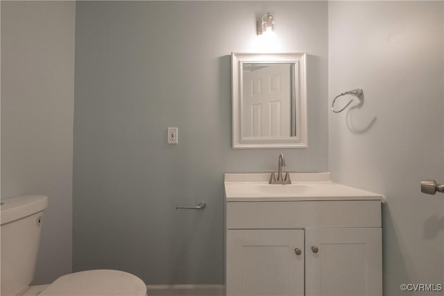 bathroom featuring toilet and vanity