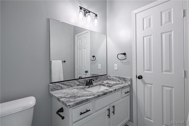 bathroom featuring toilet and vanity