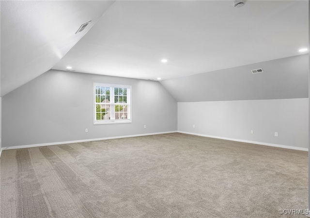 additional living space with vaulted ceiling, recessed lighting, baseboards, and carpet floors