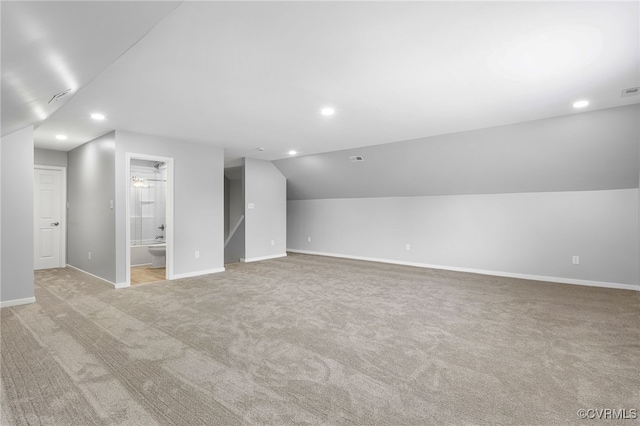 additional living space with lofted ceiling, light colored carpet, recessed lighting, and baseboards