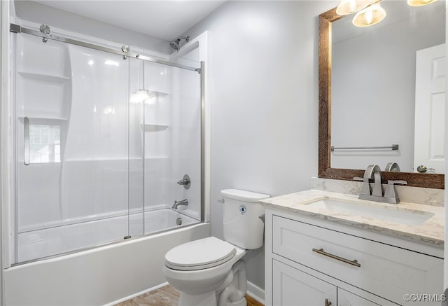 full bathroom featuring toilet, vanity, and combined bath / shower with glass door