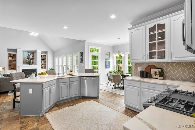 kitchen featuring appliances with stainless steel finishes, a sink, gray cabinets, light countertops, and recessed lighting