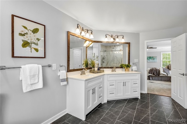 ensuite bathroom with baseboards, a marble finish shower, marble look tile flooring, and vanity