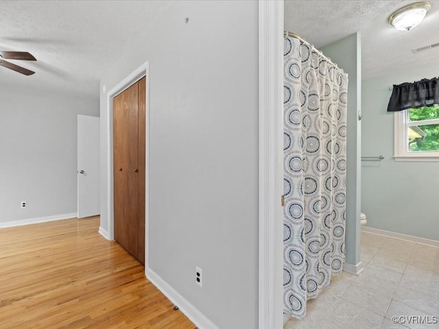 10811 Shady Ln, Charles City, VA 23030 - hall featuring a textured ceiling, baseboards, and light wood-style flooring