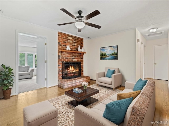 10811 Shady Ln, Charles City, VA 23030 - living room featuring wood finished floors, a ceiling fan, a fireplace, and crown molding