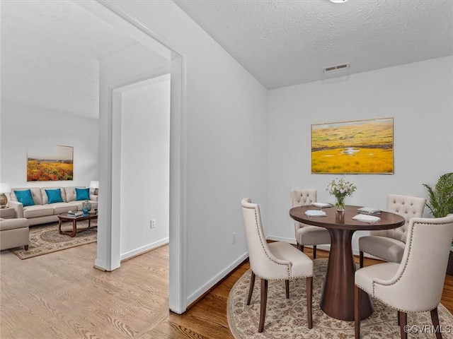 10811 Shady Ln, Charles City, VA 23030 - dining space with wood finished floors and a textured ceiling