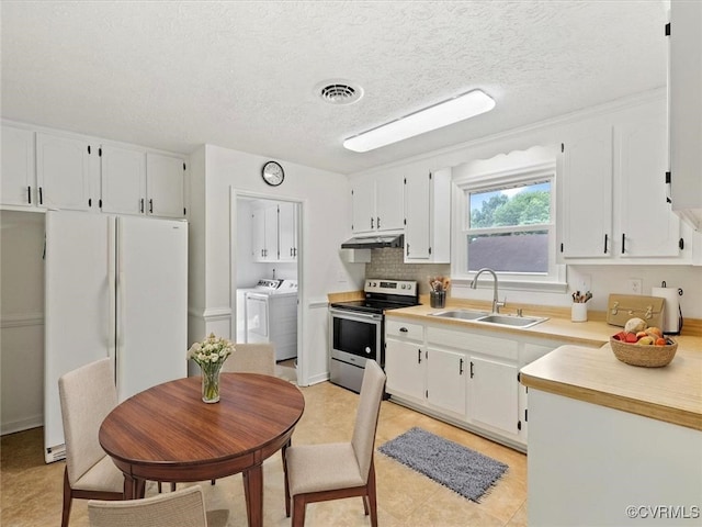 10811 Shady Ln, Charles City, VA 23030 - kitchen featuring stainless steel range with electric cooktop, a sink, washer and dryer, under cabinet range hood, and freestanding refrigerator