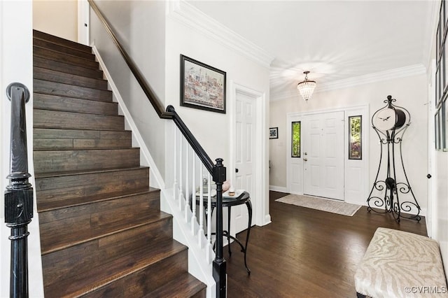 entrance foyer with stairway, baseboards, crown molding, and dark wood finished floors