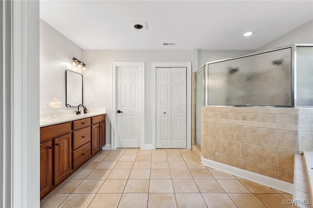 full bath featuring vanity, tile patterned floors, a shower stall, and visible vents