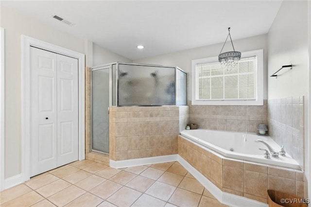 bathroom with tile patterned floors, visible vents, a bath, and a stall shower