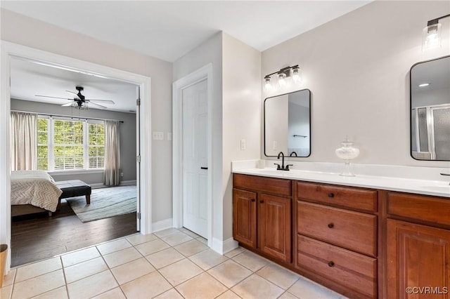 bathroom featuring a sink, tile patterned floors, ceiling fan, and double vanity