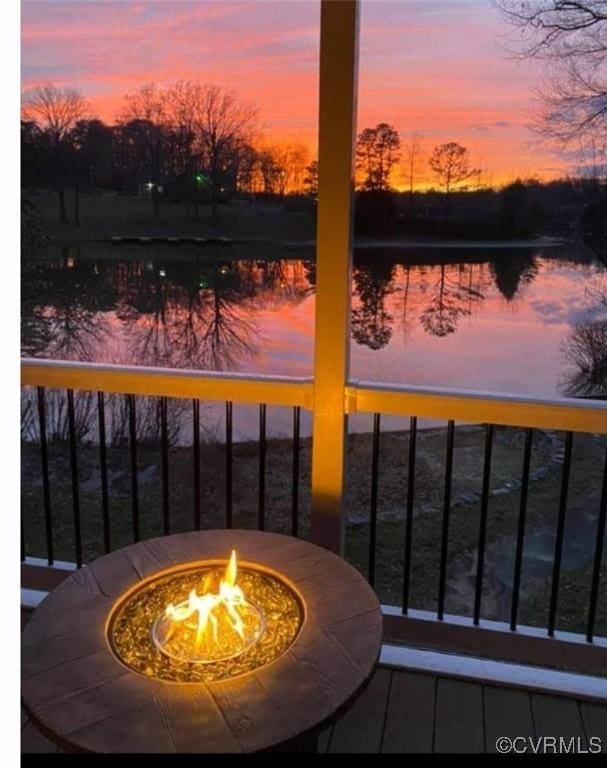 balcony with a fire pit and a water view