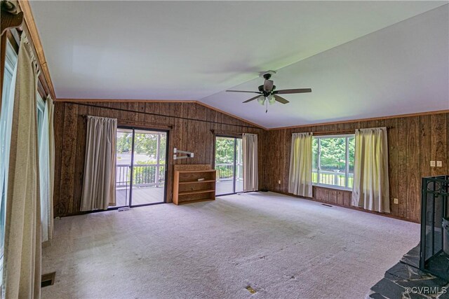 10 Mahon, Ruther Glen, VA 22546 - unfurnished living room featuring a ceiling fan, wood walls, lofted ceiling, and carpet