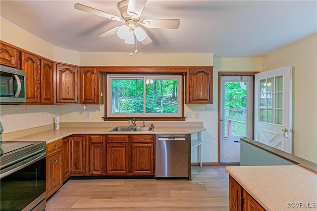 10 Mahon, Ruther Glen, VA 22546 - kitchen with stainless steel appliances, a sink, light countertops, light wood finished floors, and brown cabinets