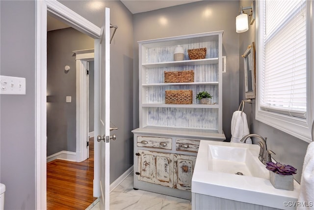 bathroom with vanity and baseboards