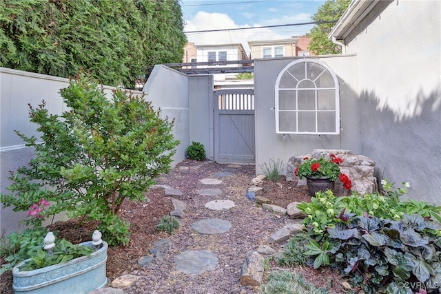 view of yard featuring fence and a gate