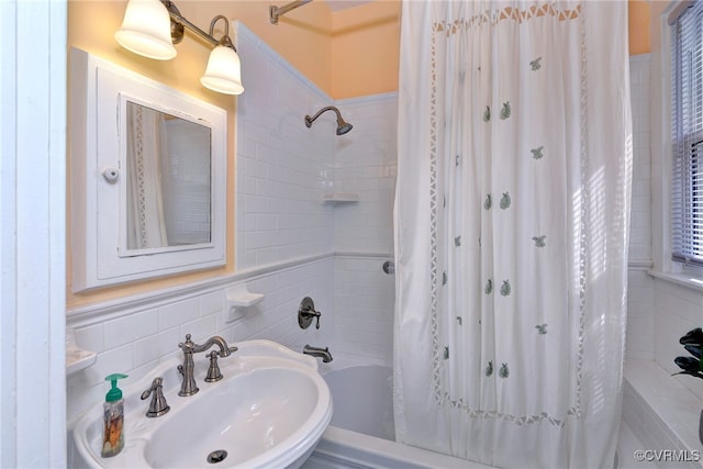 full bath with shower / bath combination with curtain and a sink