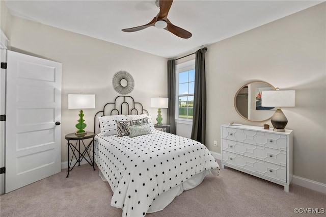 bedroom with ceiling fan, carpet floors, and baseboards