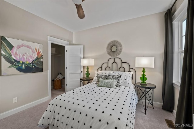 carpeted bedroom with a ceiling fan, visible vents, and baseboards