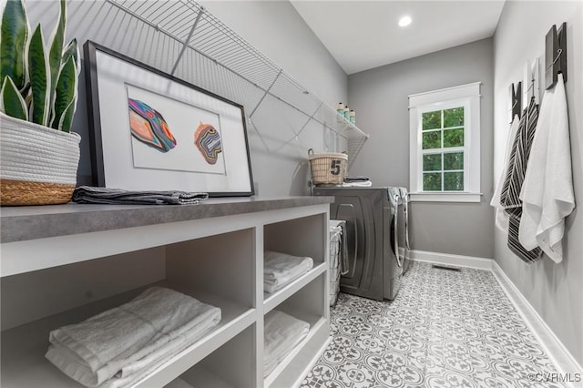 laundry area featuring washer and dryer, visible vents, laundry area, and baseboards