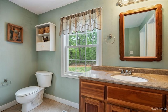 half bathroom featuring toilet, tile patterned flooring, vanity, and baseboards