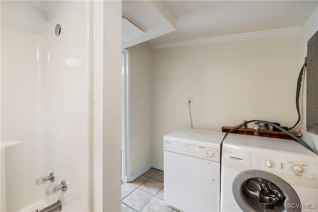 laundry room with light tile patterned flooring, washer and clothes dryer, ornamental molding, and laundry area