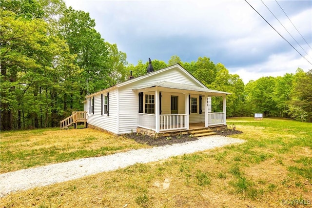 bungalow-style home with covered porch and a front lawn