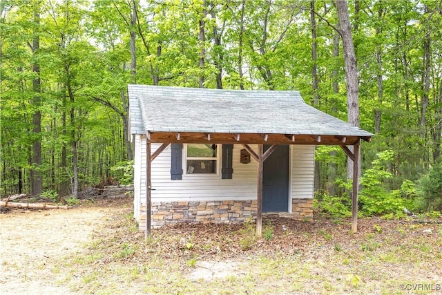 view of outbuilding featuring a wooded view