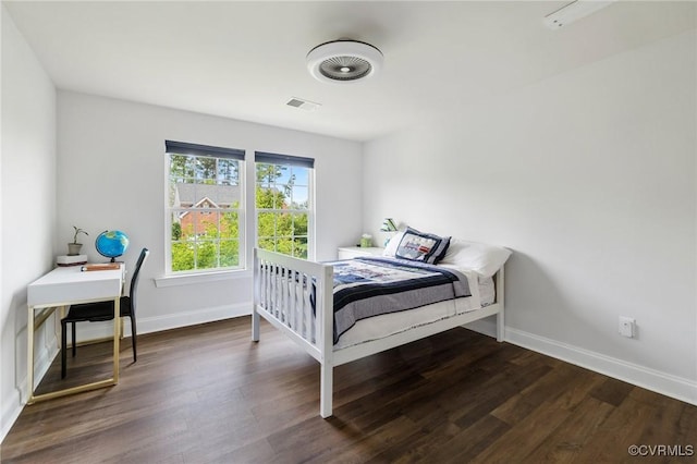 bedroom featuring dark wood-type flooring, visible vents, and baseboards