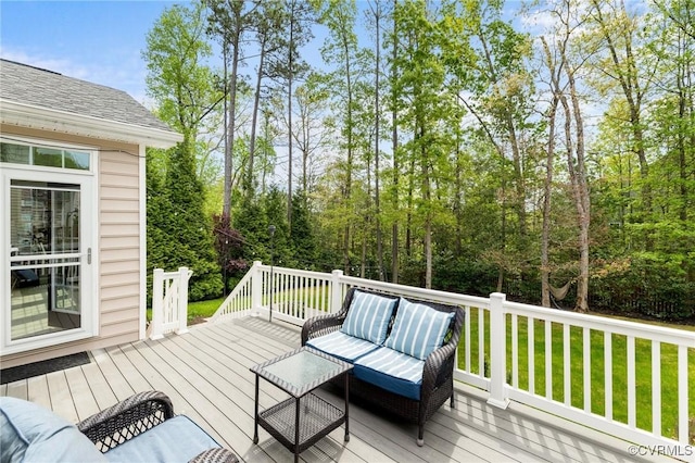 deck featuring outdoor lounge area and a yard